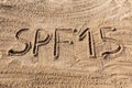 Sun protect factor fifteen concept. SPF 10 word written on the beach