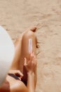 Sun protection. Closeup on female hand applying solar sun cream on Leg. Skincare. Woman smear sunscreen moisturizing lotion on her Royalty Free Stock Photo