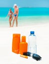 Sun protection cream, water and sun glasses Royalty Free Stock Photo