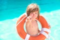 Sun protection. Happy child boy play with lifebuoy in the sea. Kid tan, suntan. Gentle kids skin tanning.