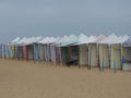 Sun protection tents on the sand of the bathing beach in the town of NazarÃ©, person resting i