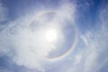 Sun with rainbow ring around it with blue sky and clouds Royalty Free Stock Photo