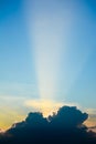 Sun ray shine through dark cloud in the sky. Royalty Free Stock Photo