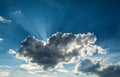 Sun rays against a blue sky in the clouds. Royalty Free Stock Photo