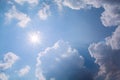 Sun rays against a blue sky in the clouds. Royalty Free Stock Photo