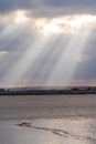 Sun rays beaming down over Thames Estuary in Essex, near purfleet, England