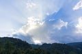 Sun rays behind cloud in the sky Royalty Free Stock Photo