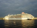 Sun rays break through storm clouds in the evening sky. Largest cruise ship in Japan