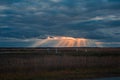 sun rays breaking through the clouds over a mountain landscape Royalty Free Stock Photo