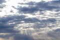 Sun rays breaking through cumulus clouds. The concept of divine light, a glimmer of hope or overcoming difficulties. Spiritual Royalty Free Stock Photo