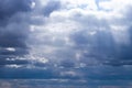 Sun rays breaking through cumulus clouds. The concept of divine light, a glimmer of hope or overcoming difficulties. Spiritual