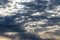 Sun rays breaking through cumulus clouds. The concept of divine light, a glimmer of hope or overcoming difficulties. Spiritual