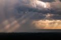 Sun rays breaking through rain clouds