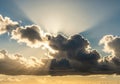 Sun rays burst through thick, dark Royalty Free Stock Photo