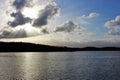 Sun rays bursting through clouds over coastal horizon Royalty Free Stock Photo