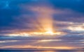 Sun Rays Bursting through Dark Blue Clouds onto the Sea Royalty Free Stock Photo
