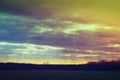 Sun rays through clouds above fields in Iowa before sunset Royalty Free Stock Photo