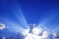 Sun rays with clouds on blue sky landscape. Royalty Free Stock Photo