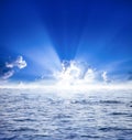 Sun rays with clouds on blue sky landscape.sunrise above clouds with reflection at ocean and very bright beams Royalty Free Stock Photo