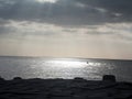 Sun rays through clouds over the sea Royalty Free Stock Photo