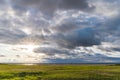 Sun rays through cloudy sky over the North Sea after storm weather at sunset Royalty Free Stock Photo