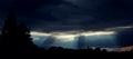 Sun rays coming out of storm clouds Royalty Free Stock Photo