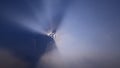 Sun rays coming out of illuminated clouds Royalty Free Stock Photo