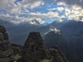 Sun rays hit the stone ruins of Machu Picchu in the Peruvian Andes at dawn Royalty Free Stock Photo