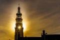 Sun rays through the Lange Jan Toren Long John Tower of the medieval Abbey from the Sun setting behind the tower in MIddelburg Royalty Free Stock Photo