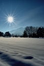 Sun rays over a snow covered field in Schaan in Liechtenstein 16.1.2021 Royalty Free Stock Photo