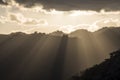 Sun rays peaking over a Southern Highland`s mountain range at sunset Royalty Free Stock Photo