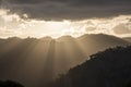 Sun rays peaking over a Southern Highland`s mountain range at sunset Royalty Free Stock Photo