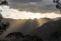 Sun rays peaking over a Southern Highland`s mountain range at sunset Royalty Free Stock Photo