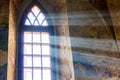 The sun rays penetrate by the window of the old church_