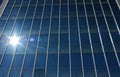 Sun rays reflecting on glass facade of building