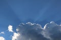 Sun rays shining from behind dark clouds Royalty Free Stock Photo