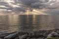 Sun rays shining through clouds over the ocean Royalty Free Stock Photo