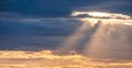 Sun rays shining through the overcast cloudy sky before rain in evening time, beautiful dramatic cloudscape sky background Royalty Free Stock Photo