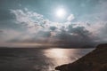 Sun rays shining though clouds over sea in Greece Royalty Free Stock Photo