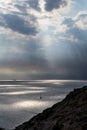 Sun rays shining though clouds over sea in Greece Royalty Free Stock Photo