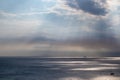 Sun rays shining though clouds over sea in Greece Royalty Free Stock Photo