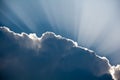 Sun rays shinning through a dark cloud Royalty Free Stock Photo