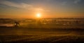 Sun rays spreading across miles of misty countryside