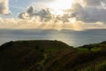 Sun Rays At Sunset Over Green Hills Royalty Free Stock Photo