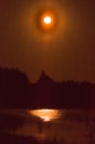 The sun is reflected in the lake at night. The moon is reflected in the water Royalty Free Stock Photo