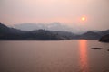 The sun reflecting on the lake through the fog and the ash of a wildfire in Yosemite National Park Royalty Free Stock Photo