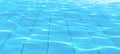 Sun reflection on the clear water ripples of swimming pool with tiles floor Royalty Free Stock Photo