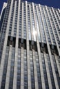 sun reflection on windows of modern very tall skyscraper in financial district Royalty Free Stock Photo