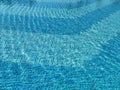 Sun reflections in a pool water above a blue pool tile Royalty Free Stock Photo