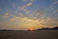 Sun rise on the horizon where two sand tracks join